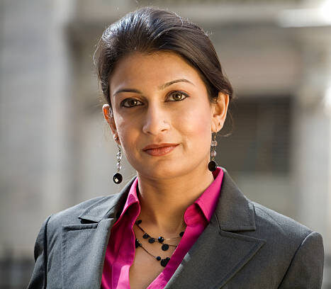 Friendly Indian Businesswoman Wearing a Suit in City Setting